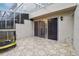 Cozy outdoor patio with decorative tile, sliding glass doors, and ample space for entertaining at 2794 Countryside Blvd # 1, Clearwater, FL 33761