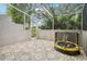 Enclosed patio with patterned tile flooring, white frame, and outdoor seating; ideal for relaxing or entertaining at 2794 Countryside Blvd # 1, Clearwater, FL 33761