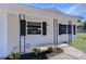 Inviting front porch with wrought iron accents and modern security system, enhancing curb appeal at 5836 8Th St, Zephyrhills, FL 33542