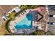 Aerial shot of a community pool surrounded by lounge chairs and palm trees at 6333 Osprey Lake Cir, Riverview, FL 33578