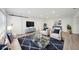 Comfortable living room featuring stylish seating, a glass coffee table, and modern decor at 4318 1St S Ave, St Petersburg, FL 33711