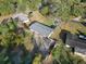 An aerial view of the home showcasing its spacious lot and metal roof at 5059 Mockingbird Dr, Dade City, FL 33523
