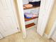 Linen closet with wooden shelves containing folded towels and bedding at 5059 Mockingbird Dr, Dade City, FL 33523