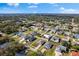 An aerial view showing a lovely home in a well-maintained neighborhood with lush, mature trees on a sunny day at 1203 Desmond St, Port Charlotte, FL 33952