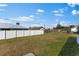 Spacious backyard with a white vinyl fence and healthy green lawn at 1203 Desmond St, Port Charlotte, FL 33952