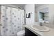 Clean bathroom featuring a shower, sink, toilet and decorative shower curtain at 1203 Desmond St, Port Charlotte, FL 33952