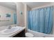 Bathroom with shower and tub, toilet and vanity with large sink and mirror at 1203 Desmond St, Port Charlotte, FL 33952