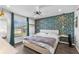 Stylish bedroom with accent wall, comfortable bed, and modern lighting fixtures at 1203 Desmond St, Port Charlotte, FL 33952
