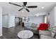 Open-concept living space with a gray sectional, stainless appliances, and a breakfast bar at 1203 Desmond St, Port Charlotte, FL 33952