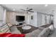 Spacious living room featuring gray seating, a marble coffee table, and a mounted TV at 1203 Desmond St, Port Charlotte, FL 33952
