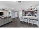 Open living space with a modern kitchen, bar seating, and comfortable lounge area at 1203 Desmond St, Port Charlotte, FL 33952