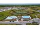 Aerial view showcases community amenities: swimming pools, clubhouse, and lush landscaping in a desirable neighborhood at 14215 Swiss Bridge Dr, Riverview, FL 33579