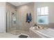 Main bathroom features a luxurious shower, tub and natural lighting at 14215 Swiss Bridge Dr, Riverview, FL 33579