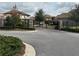 Community entrance gate featuring black iron and stone pillars offers privacy and security to residents at 14215 Swiss Bridge Dr, Riverview, FL 33579