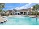 Community pool featuring splash pad, lounge chairs, and outdoor seating at 14215 Swiss Bridge Dr, Riverview, FL 33579