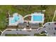 Aerial view of community pools with lap lanes, beach entry, and lots of lounge chairs at 14215 Swiss Bridge Dr, Riverview, FL 33579