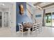 The dining room features a wood table, six chairs, staircase, and glass sliding doors to the pool at 14215 Swiss Bridge Dr, Riverview, FL 33579