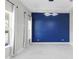 Bright dining room with modern lighting and a vibrant blue accent wall provides an elegant and inviting space at 14215 Swiss Bridge Dr, Riverview, FL 33579