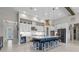 A modern kitchen features white cabinetry, stainless appliances, a large island, and stylish lighting at 14215 Swiss Bridge Dr, Riverview, FL 33579
