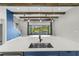 Modern kitchen island with a sink and sleek faucet faces sliding glass doors that open to the pool area at 14215 Swiss Bridge Dr, Riverview, FL 33579