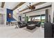 The open living area features a gourmet kitchen, comfortable seating, and large sliding doors to the pool at 14215 Swiss Bridge Dr, Riverview, FL 33579