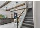 Staircase near a living room with wood beams, a modern kitchen and open concept design at 14215 Swiss Bridge Dr, Riverview, FL 33579