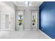 Bright, open living area with white tile floors, large windows, and an accent wall, perfect for entertaining at 14215 Swiss Bridge Dr, Riverview, FL 33579