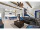 The open living area features a gourmet kitchen, comfortable seating, and large sliding doors to the pool at 14215 Swiss Bridge Dr, Riverview, FL 33579