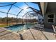 Beautiful screened pool with outside seating, pavers, and nice view at 14215 Swiss Bridge Dr, Riverview, FL 33579