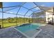 Sparkling pool within a screened enclosure, features tiled steps and a tranquil view of the lush surroundings at 14215 Swiss Bridge Dr, Riverview, FL 33579