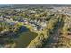 Expansive aerial view of the neighborhood featuring a large pond, lush trees, and well-maintained homes at 2307 Dakota Rock Dr, Ruskin, FL 33570