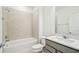 Bathroom with a tiled shower over tub, gray vanity, and neutral walls at 4306 Big Sky Dr, Spring Hill, FL 34604