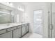 Modern bathroom featuring double vanity, grey cabinets, quartz countertops, a glass-enclosed shower, and tile flooring at 4306 Big Sky Dr, Spring Hill, FL 34604