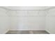 This is an empty walk-in closet featuring wire shelving and neutral carpet at 4306 Big Sky Dr, Spring Hill, FL 34604