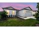 Charming home exterior featuring a two-car garage, manicured lawn, and attractive landscaping at 4306 Big Sky Dr, Spring Hill, FL 34604