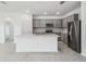 Open kitchen featuring grey cabinets, stainless steel appliances, a large island, and tile flooring at 4306 Big Sky Dr, Spring Hill, FL 34604