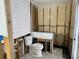 Bathroom renovation with new toilet, exposed studs, and modern white wall at 4826 W San Jose St, Tampa, FL 33629