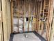 Bathroom renovation with new shower base, exposed studs, and updated plumbing at 4826 W San Jose St, Tampa, FL 33629
