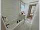 Renovated bathroom with white subway tile, soaking tub, and marble flooring at 4826 W San Jose St, Tampa, FL 33629