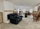 Renovated living room with white brick fireplace, exposed studs, and open staircase at 4826 W San Jose St, Tampa, FL 33629