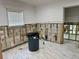 Under-renovation living room with modern tile, shiplap wall accents and natural light from a large window at 4826 W San Jose St, Tampa, FL 33629