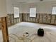 Spacious living room with exposed block walls, three windows, and potential for customization at 4826 W San Jose St, Tampa, FL 33629