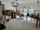 Under-renovation living area with exposed framing, bright lighting, and sliding door access to the backyard at 4826 W San Jose St, Tampa, FL 33629
