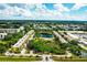 High angle aerial of condo community featuring a private pool, lake, and tennis court at 5849 Park N St # 201, St Petersburg, FL 33709