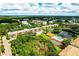 Scenic aerial view of the community featuring a swimming pool, tennis court and tranquil lake at 5849 Park N St # 201, St Petersburg, FL 33709