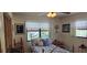 Comfortable bedroom with a ceiling fan and decorative elements, featuring a window view at 5849 Park N St # 201, St Petersburg, FL 33709
