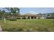 Exterior shot of the community clubhouse with lush green lawn at 5849 Park N St # 201, St Petersburg, FL 33709
