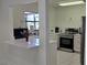 Bright, modern kitchen featuring white cabinets, stainless steel appliances, and a quartz breakfast bar at 5849 Park N St # 201, St Petersburg, FL 33709