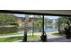 Scenic view of a pond with a fountain surrounded by trees and community buildings at 5849 Park N St # 201, St Petersburg, FL 33709