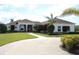 Beautiful single story home featuring an elegant entryway, lush lawn, and a winding driveway bordered with pavers at 6367 Foxbrook Trl, Parrish, FL 34219